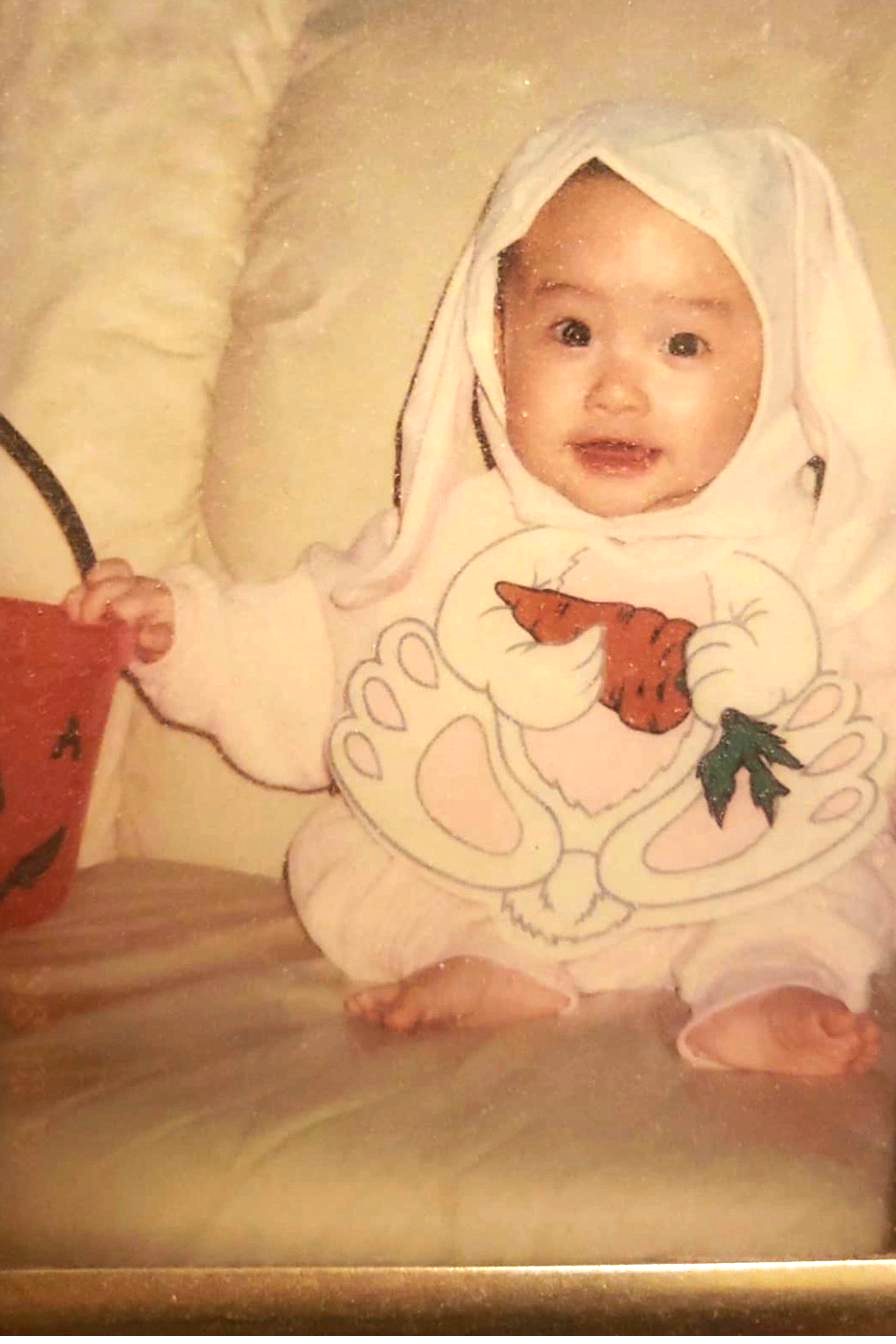 Jocelyn as a baby in a white bunny outfit